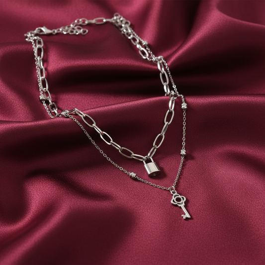 Lock and key necklaces on satin background
