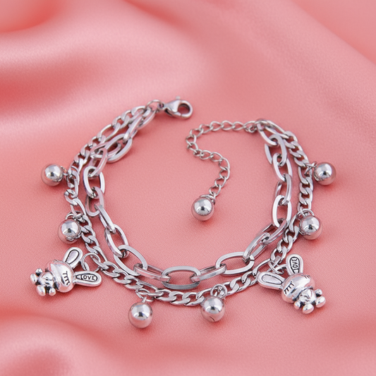 Rabbit charm bracelet on coral pink satin background