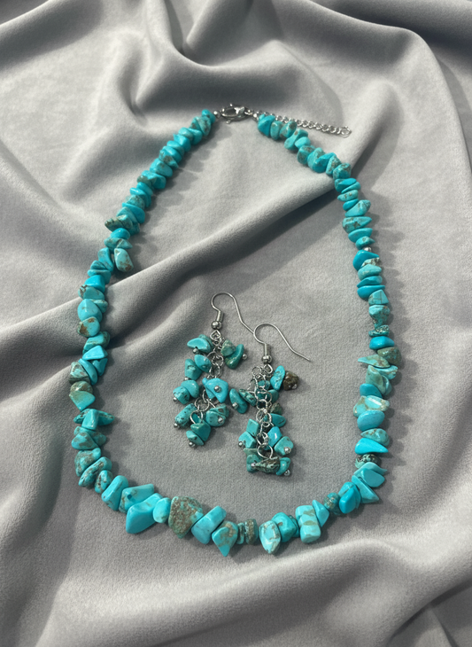 Turquoise jewelry on gray fabric
