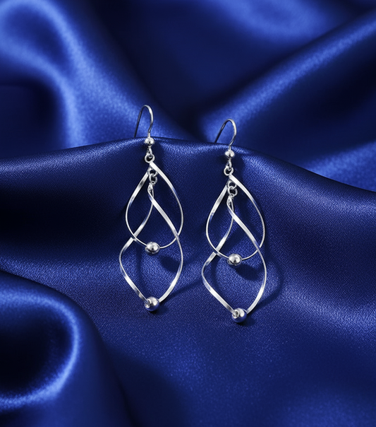 Twisted earrings on blue satin