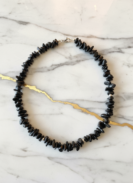 Black agate necklace on elegant marble background