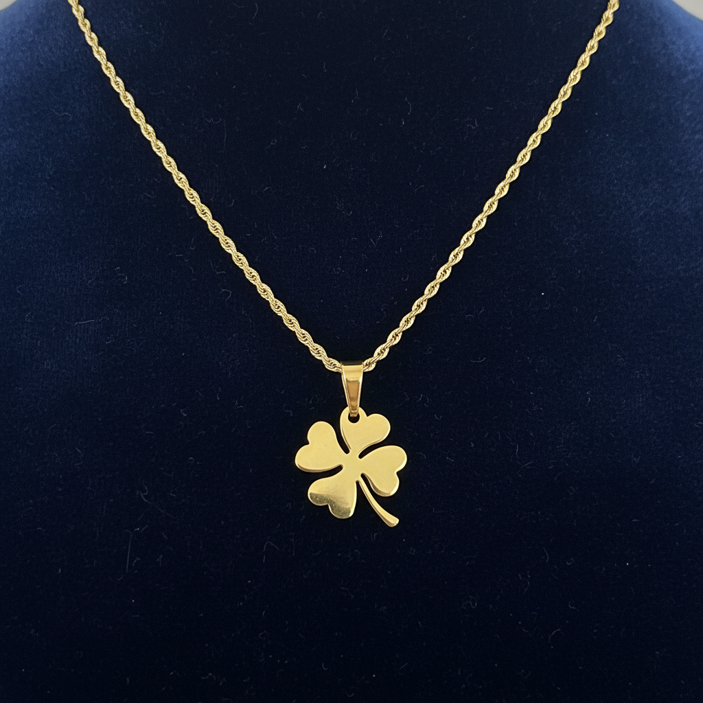 Gold clover necklace on navy blue velvet background