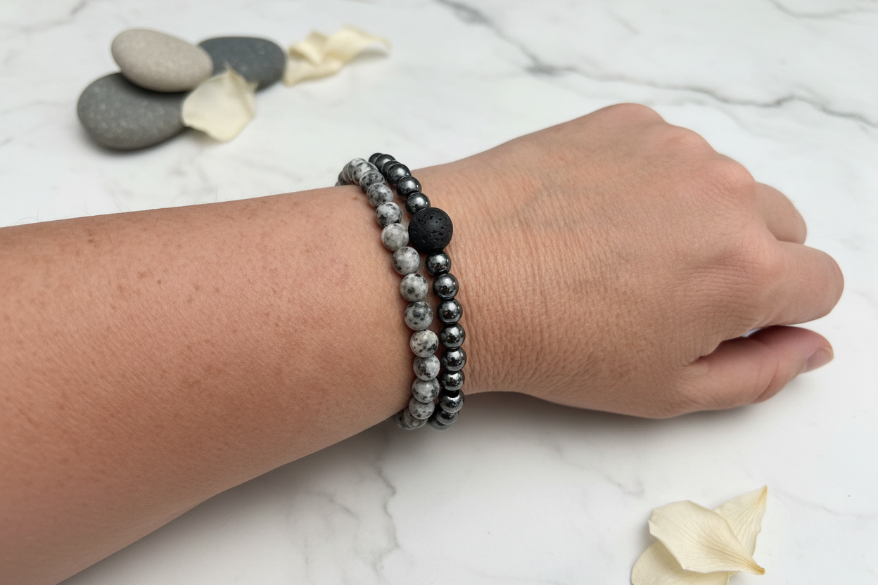 Grey stone and hematite bracelets on wrist