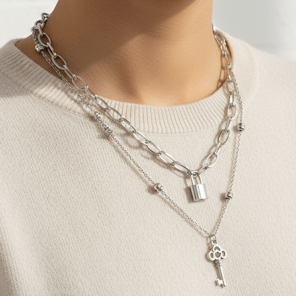 Model wearing lock and key necklaces