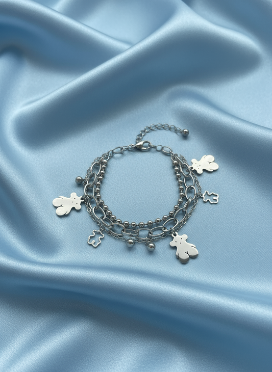Teddy bear bracelet on baby blue satin background